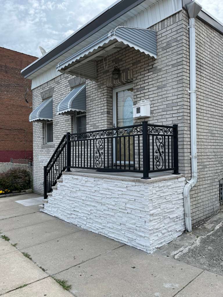 Ornamental aluminum railings on brick porch in NJ